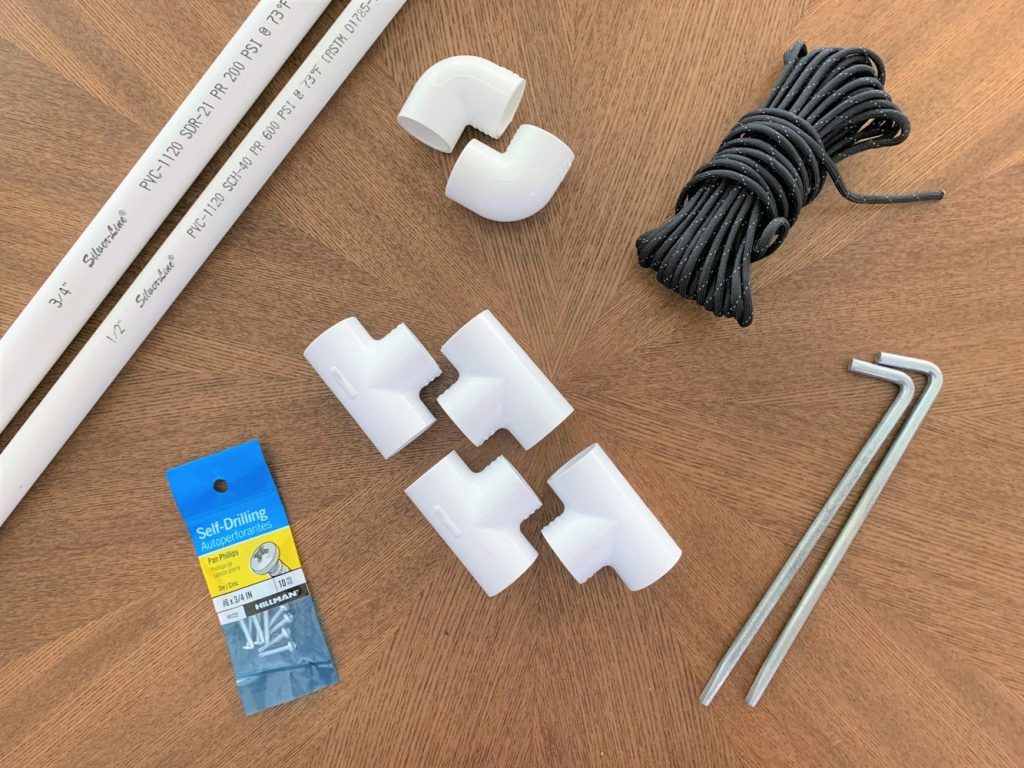 Materials for building a DIY solar panel mount laid out on a wooden table