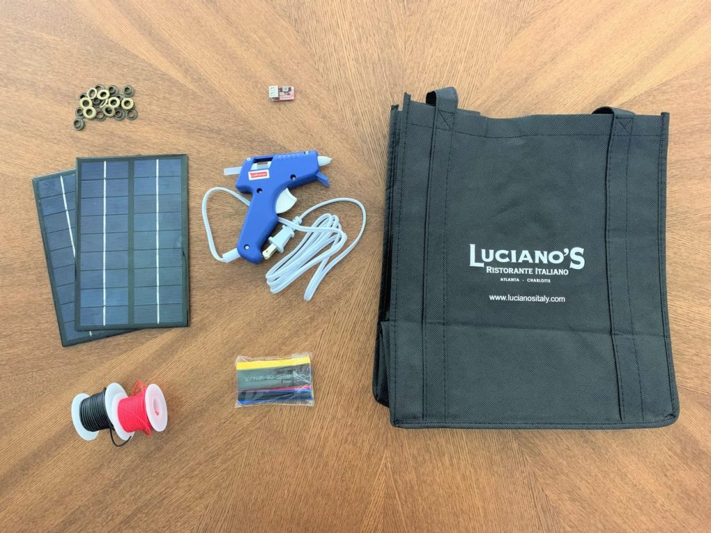 Materials for building a DIY solar USB charger laid out on a wooden table