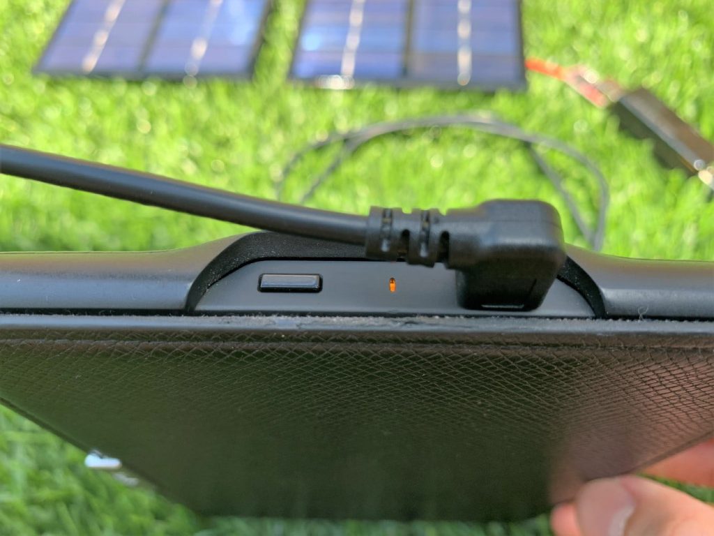 A solar charger charging a Kindle