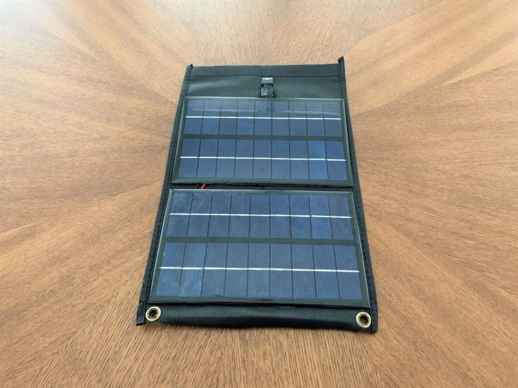 A DIY solar phone charger with two eyelets at the bottom