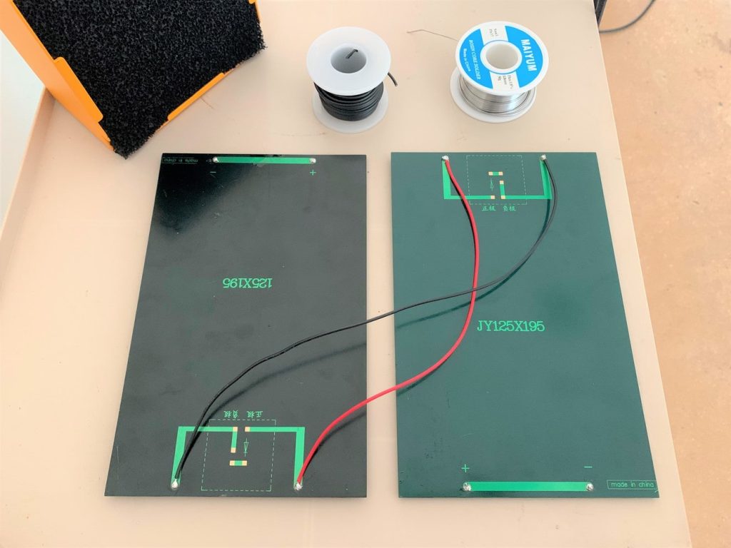 Two 9-volt solar panels wired together with red and black 22 AWG wire