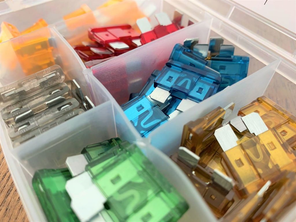 A box of different colored fuses of various amperage ratings